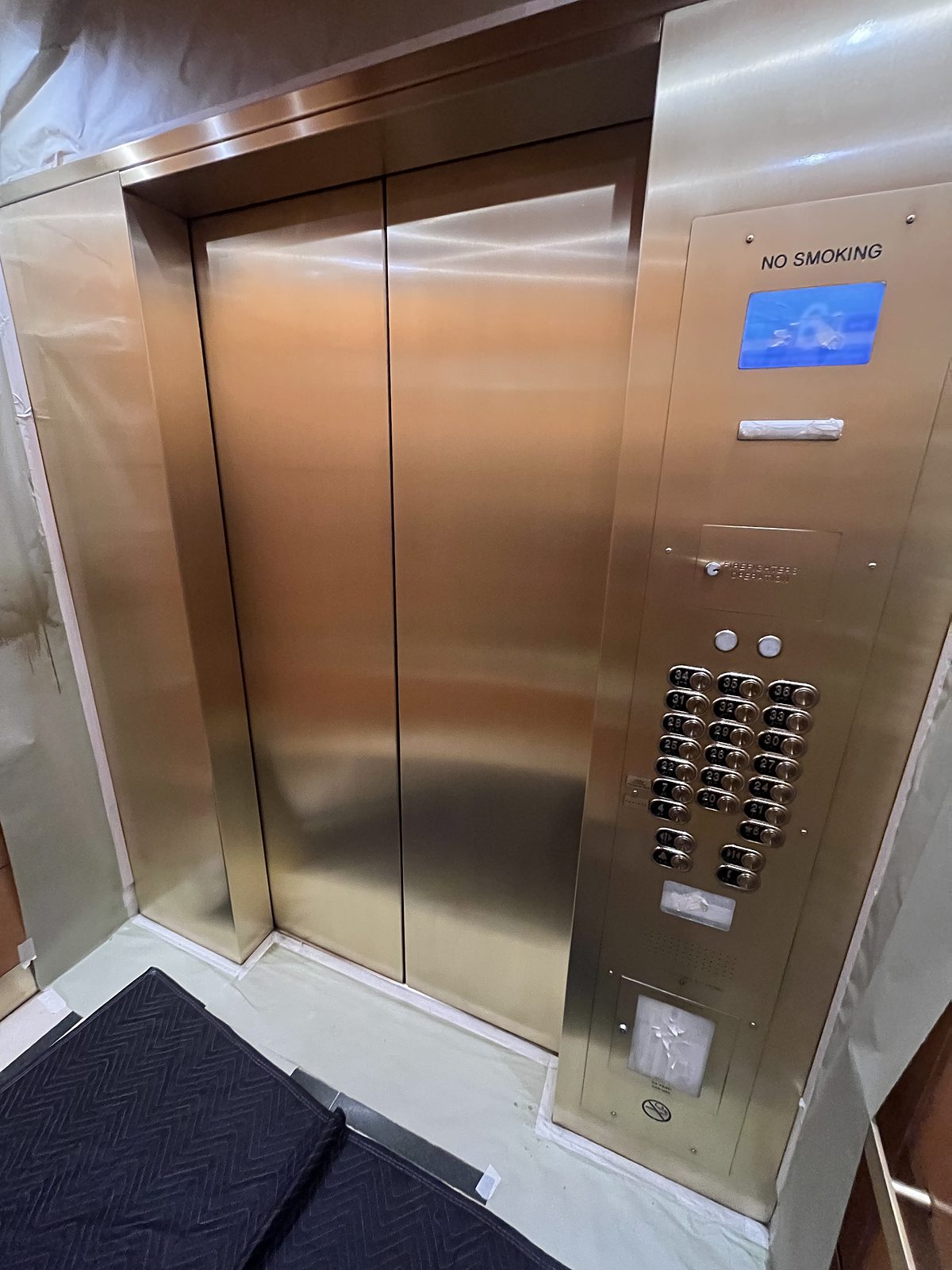 Bronze cab interior and call panel, finished and protected